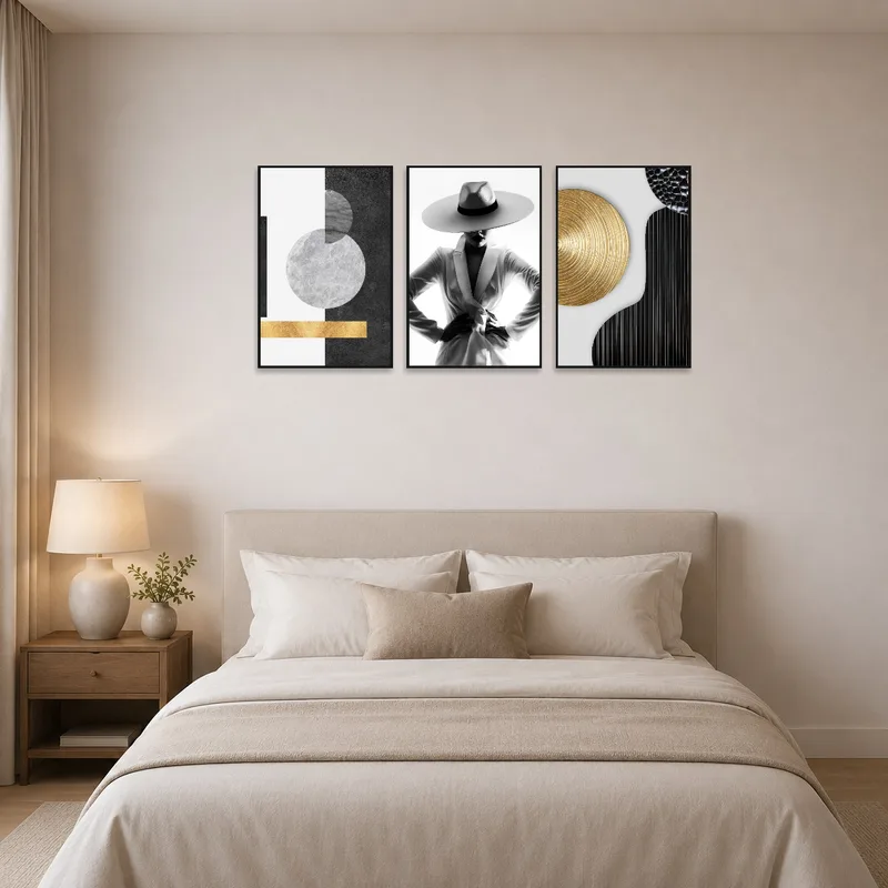 Chic black and white fashion triptych elegantly displayed above a bed in the bedroom.