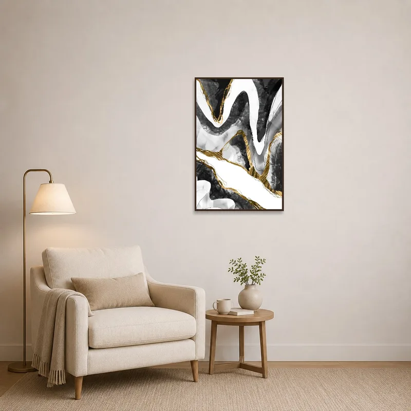 Abstract black and gold wave art print beside a cozy reading corner with a chair and lamp.