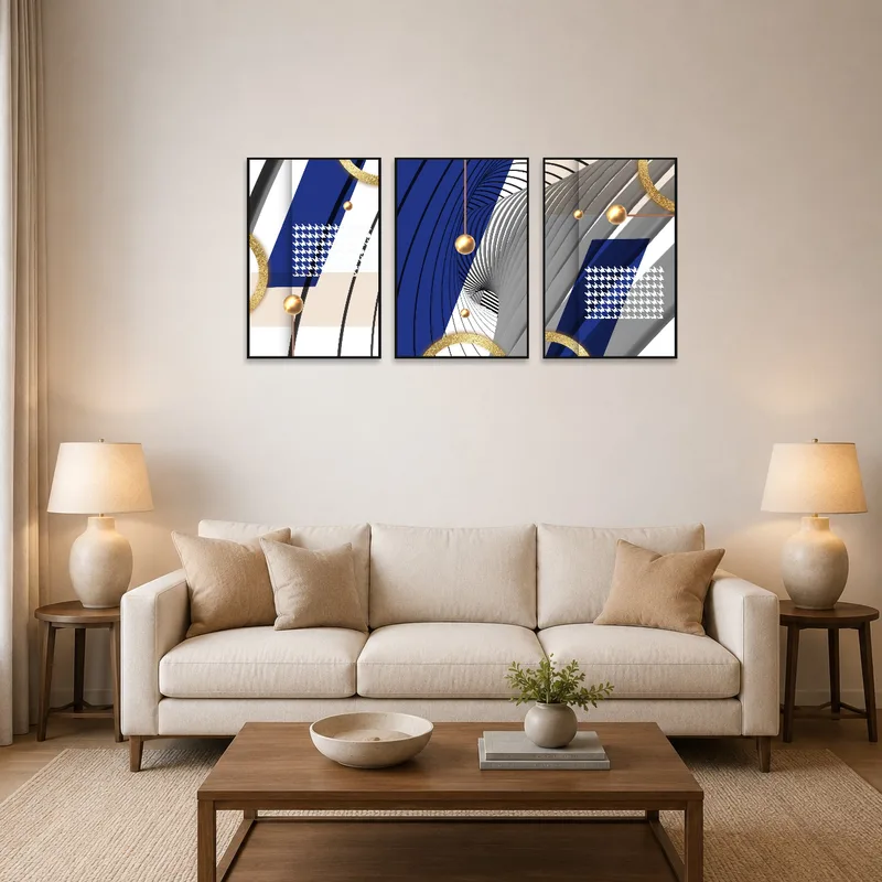 A blue and gold triptych hangs above a modern sofa in a living room.
