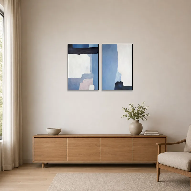 Minimalist room with abstract blue and white tones art set on a plain wall.