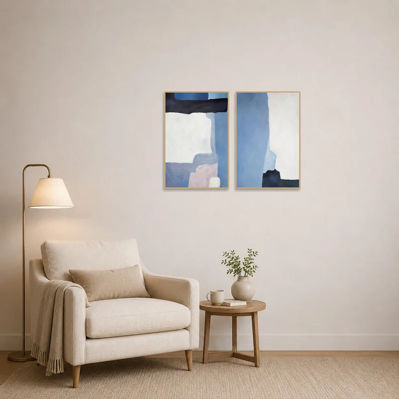 A reading corner featuring abstract blue and white tones art set on the wall.