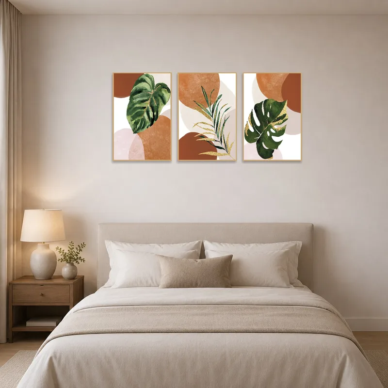 Botanical triptych in muted earth tones brings warmth to a calming bedroom.