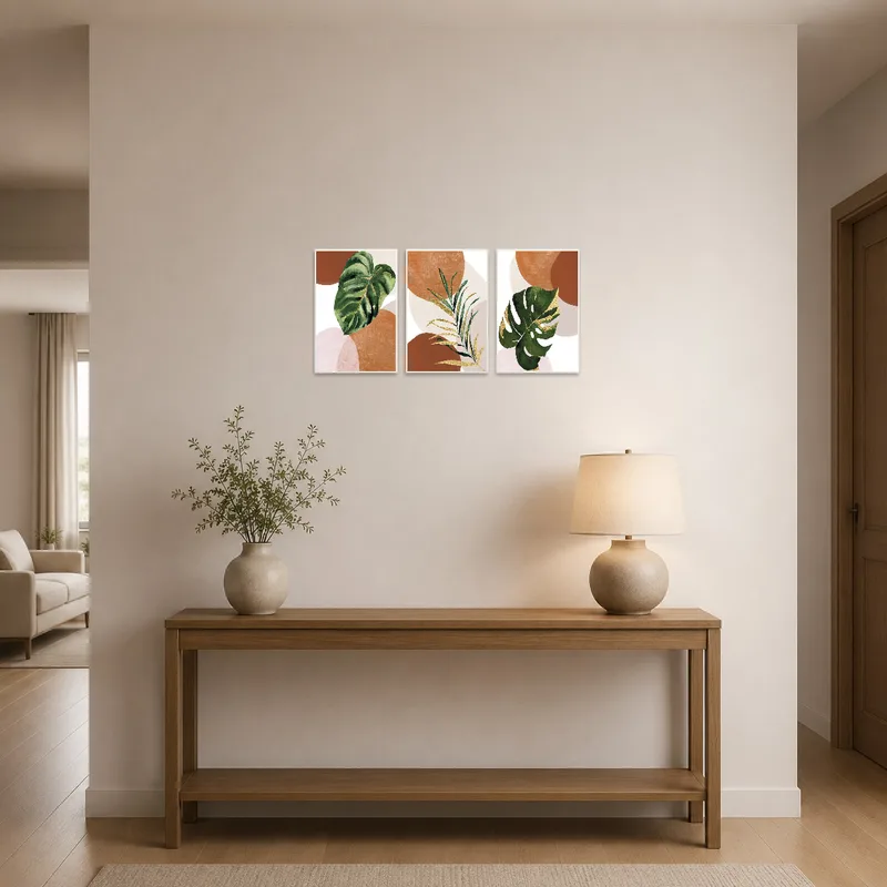 Warm botanical triptych welcomes guests in an entrance hall with earthy vibes.