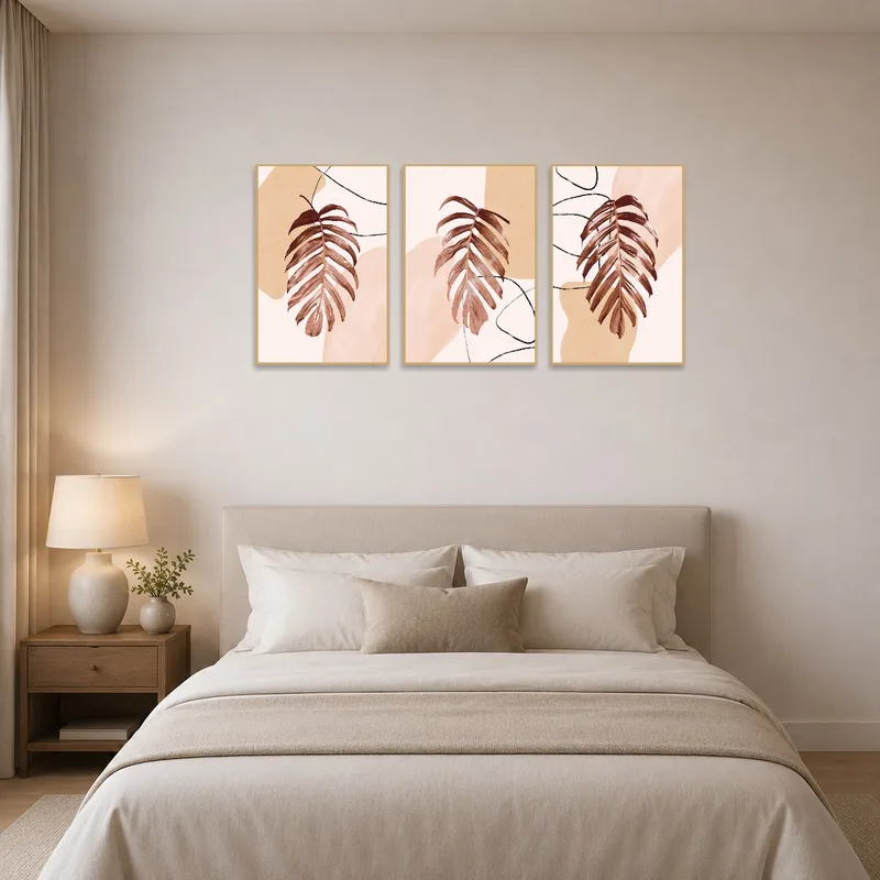 Bedroom wall decorated with an abstract botanical triptych in soothing earthy colors.