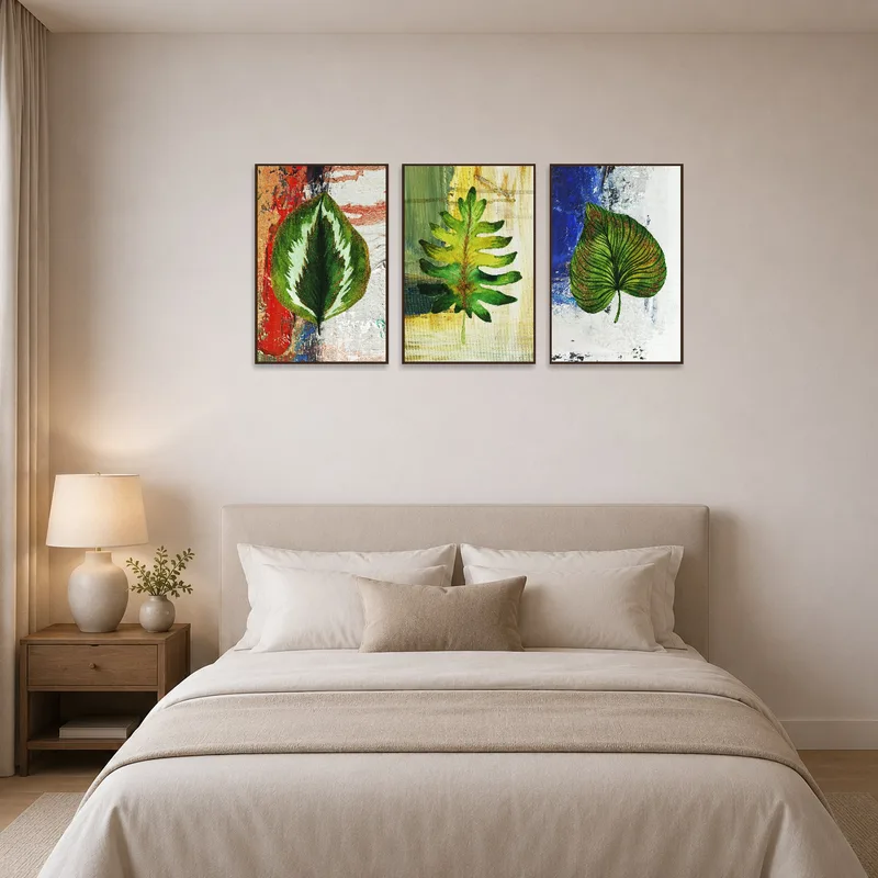 Abstract leaf pattern triptych positioned above the bed in a serene bedroom.
