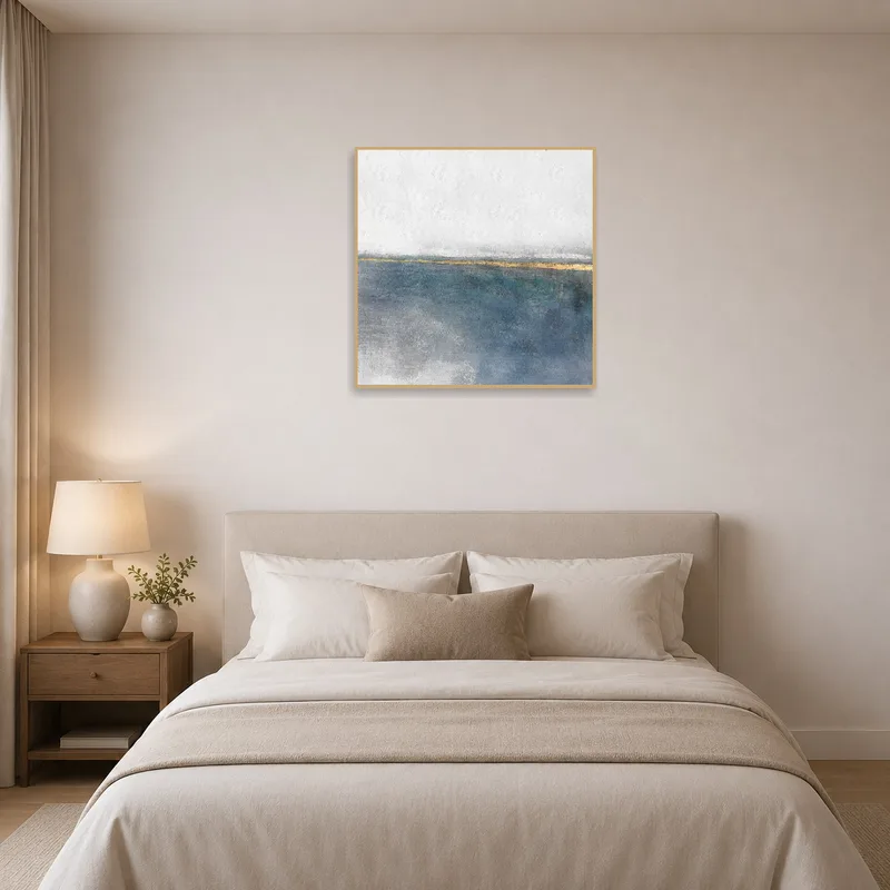 Serene abstract coastal print enhances a peaceful bedroom.