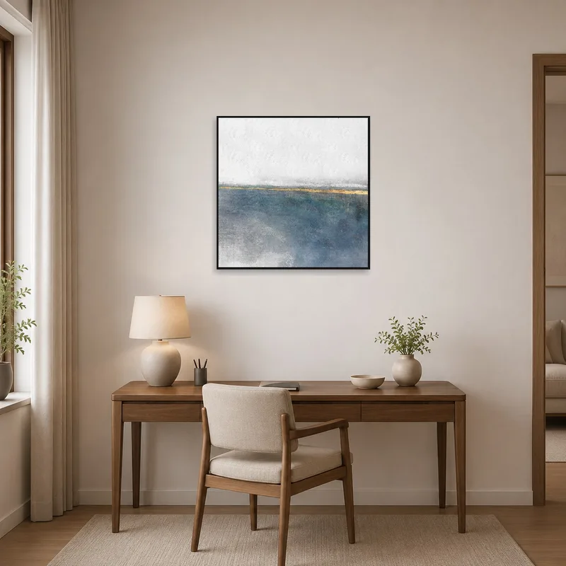 Coastal-themed abstract print above a desk in a home office.