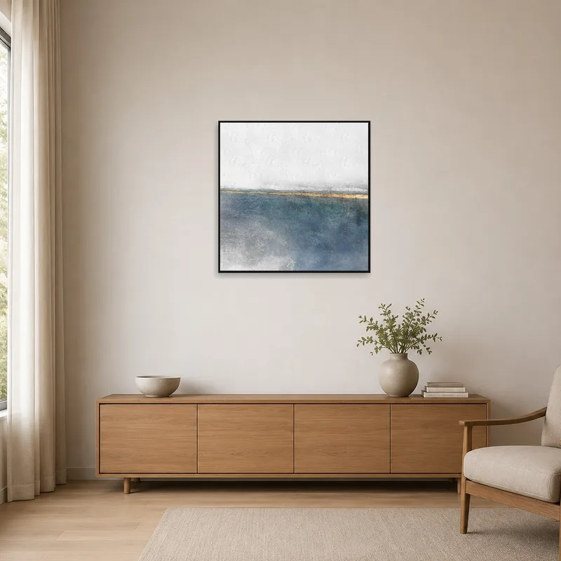 Minimalist room with a solitary coastal-themed square art piece.