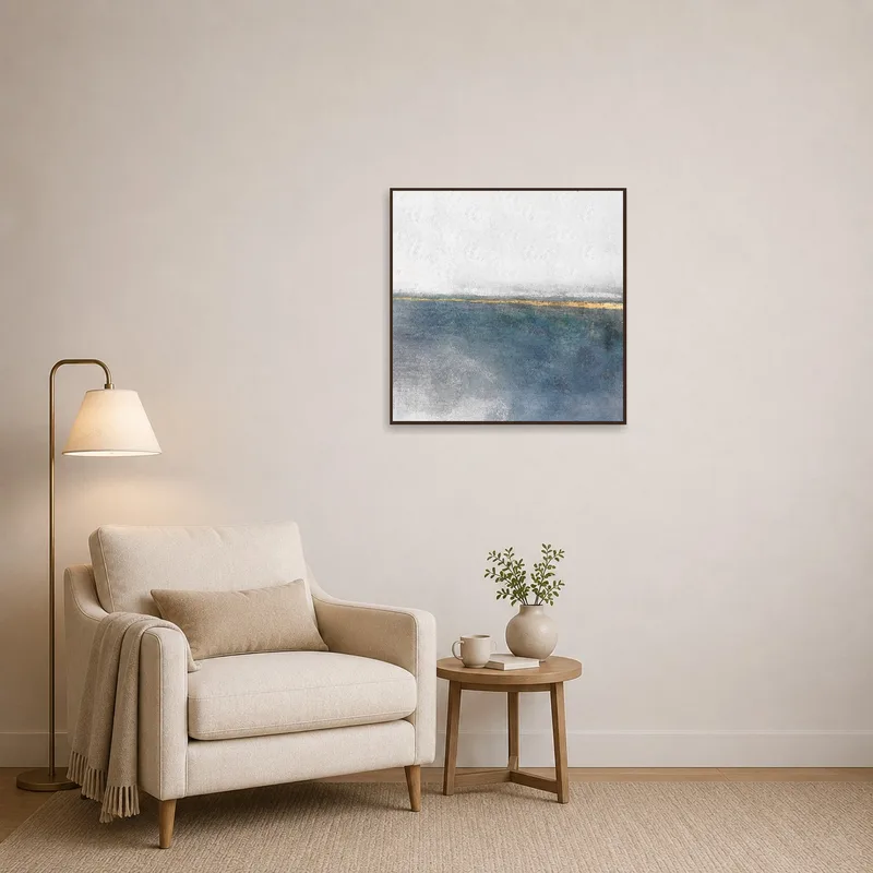 Square coastal artwork adds charm to a cozy reading corner.
