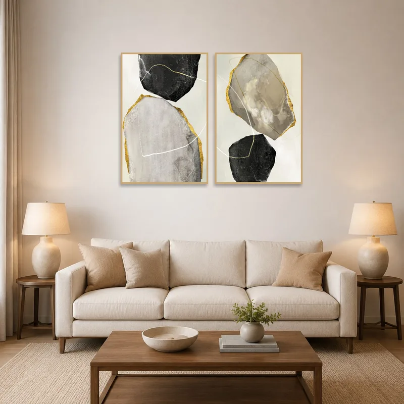 Earth tones and gold artwork adding warmth above a modern living room sofa.