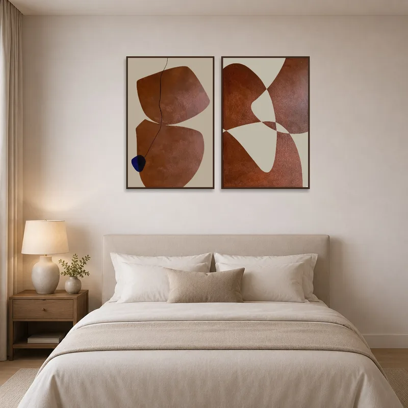 Warm-toned abstract triptych pieces hanging above the bed, adding comfort to the bedroom.