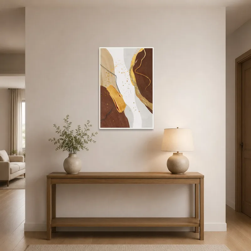 Abstract art with earth tones and gold accents displayed in an entrance hall.