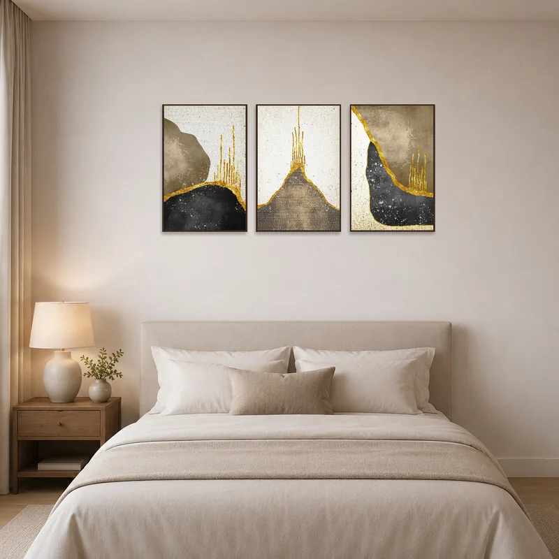 Earthy and gold abstract triptych enhancing the calming atmosphere above a bed.