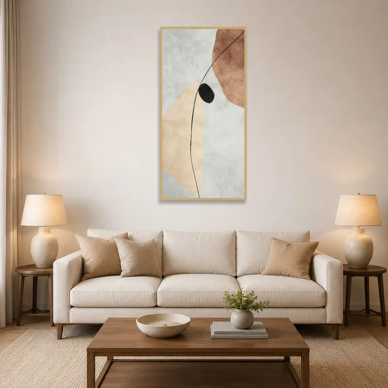 Abstract earthy tones art with black accent on a living room wall above a cozy sofa.