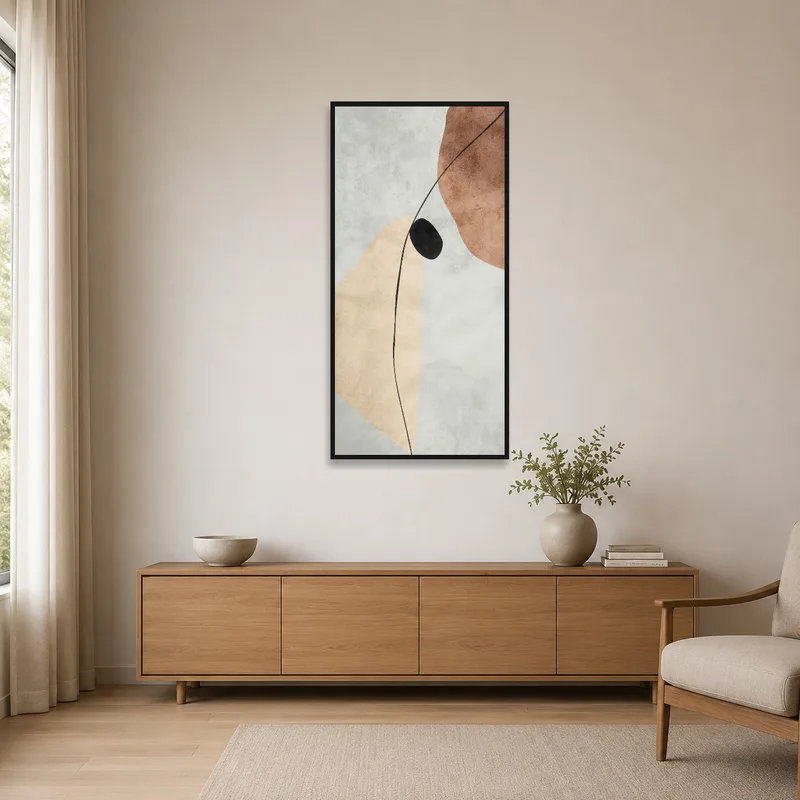 Abstract art of earthy tones with black accent on a minimalist wall, complementing sparse decor.