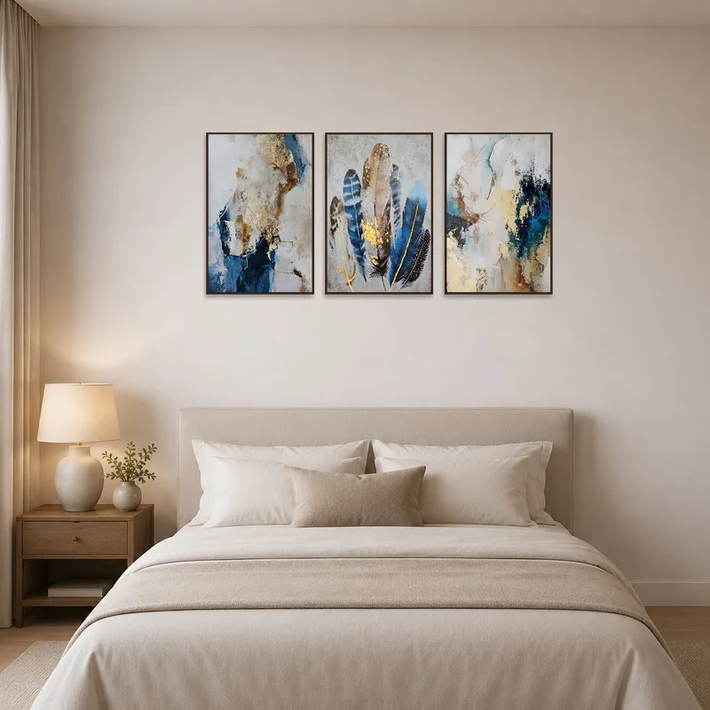 Serene bedroom ambiance with feather triptych on wall.