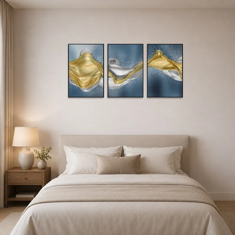 Elegant triptych creates a calming atmosphere in the bedroom with flowing metallic tones.