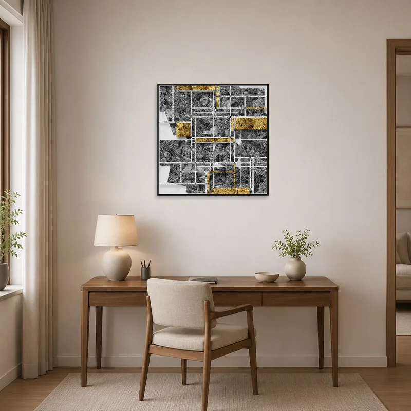Home office with an abstract geometric art print in gold and gray adding a stylish touch.