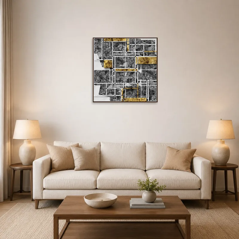 Abstract geometric art print in gold and gray over a modern sofa in a chic living room.