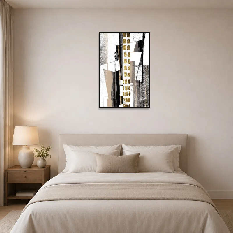 Elegant geometric print with gold accents above a bed with neutral linens.