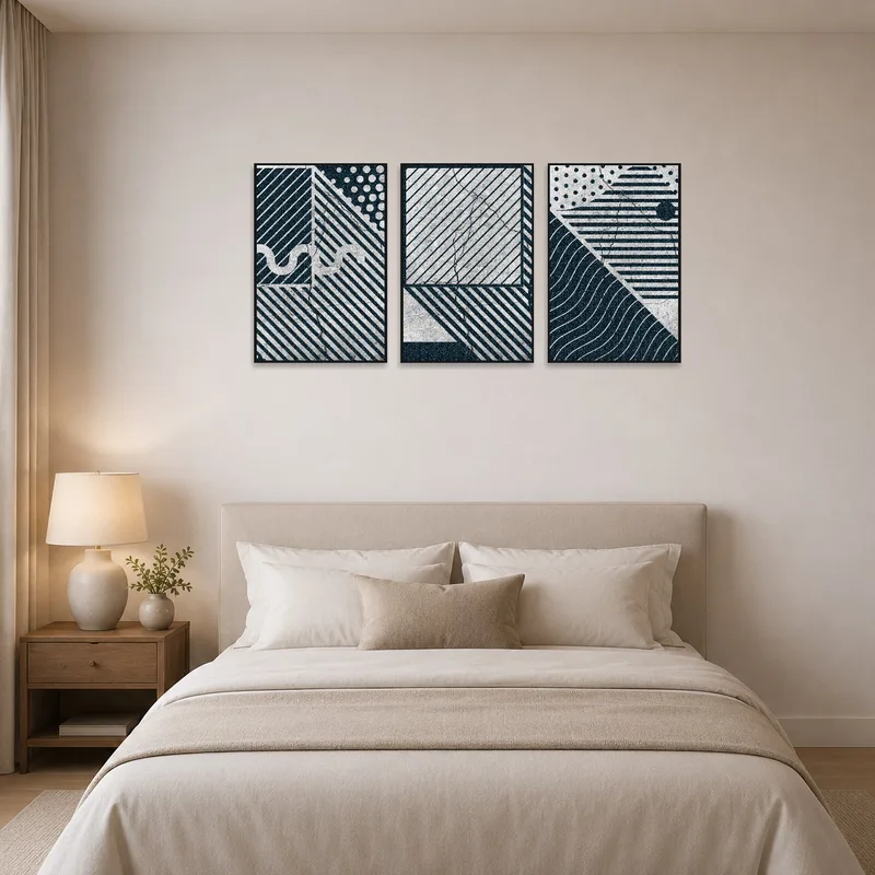 Abstract geometric art above a bed with soft linens.