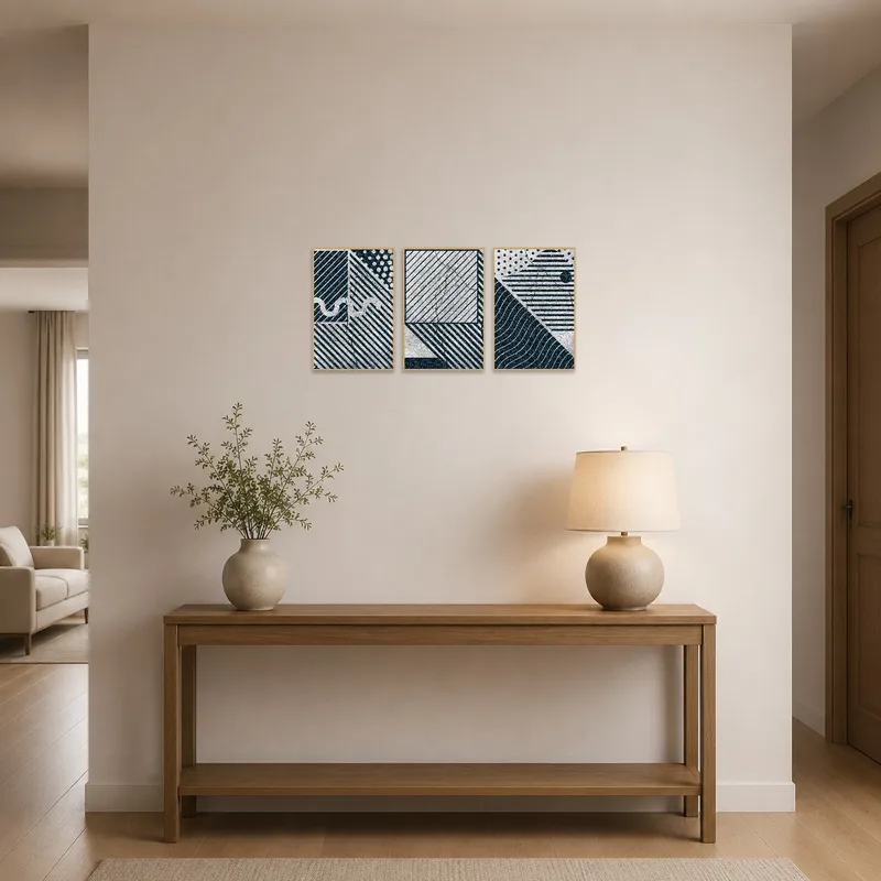 Geometric art contrasts with a sleek entrance hall console.