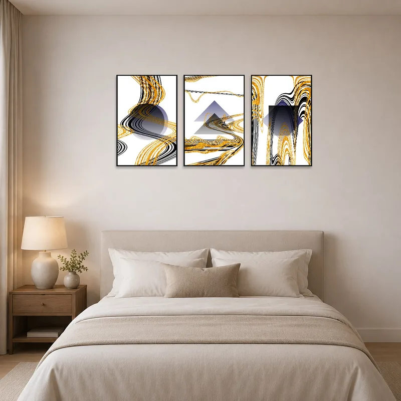 Elegant geometric triptych in gold and black adorns a bedroom wall.