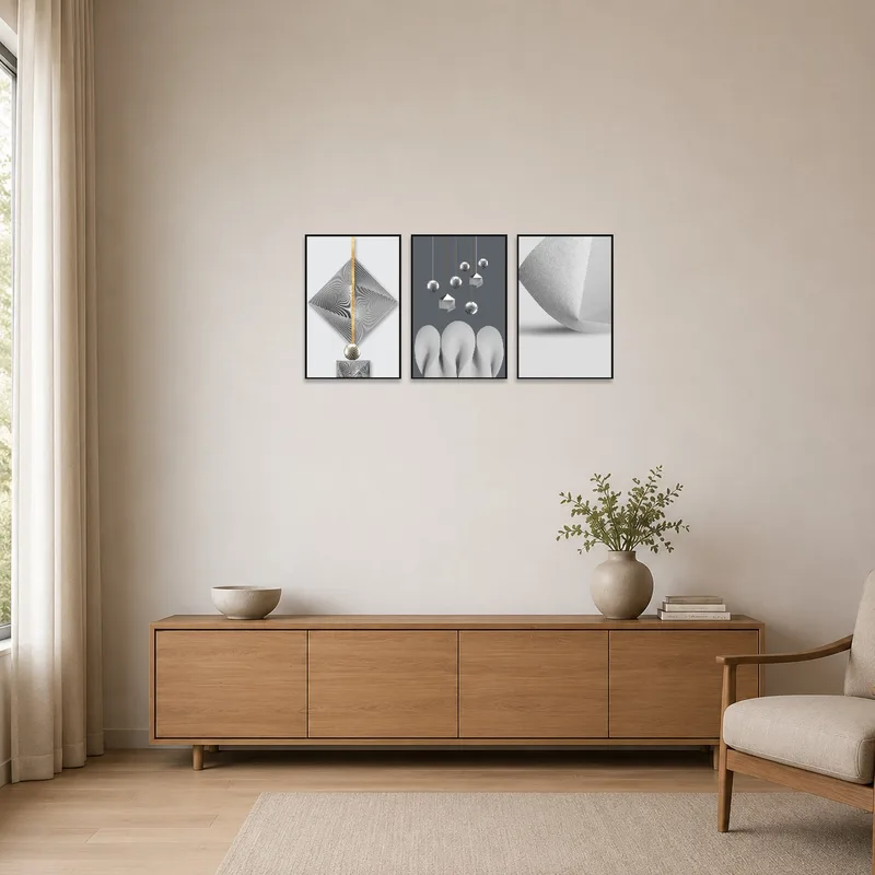 Geometric triptych with metallic accents in a minimalist room, emphasizing clean lines and simplicity.