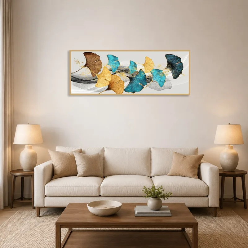Abstract ginkgo leaf art in blue and gold on a living room wall above a modern couch.