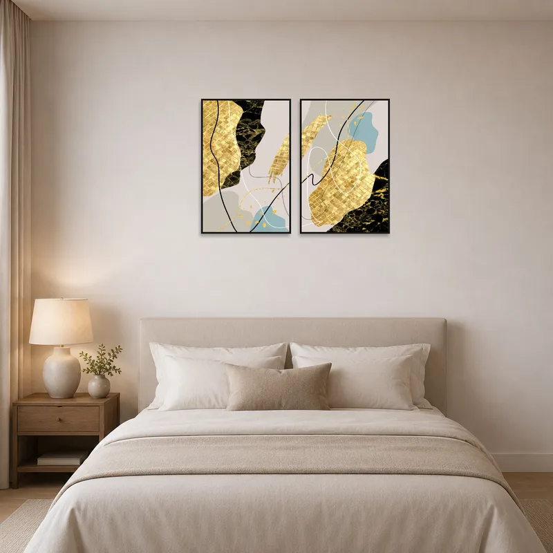 Abstract gold and black art set adding sophistication to a serene bedroom setting.