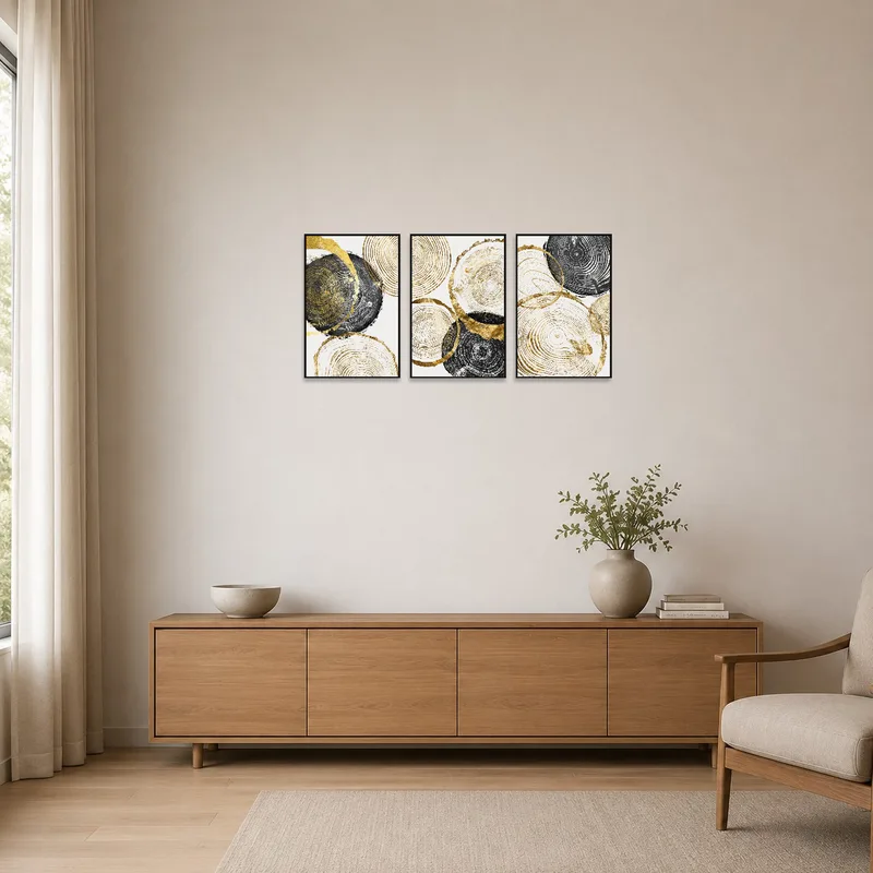 Minimalist space accented by abstract tree ring art panels in gold and black tones.