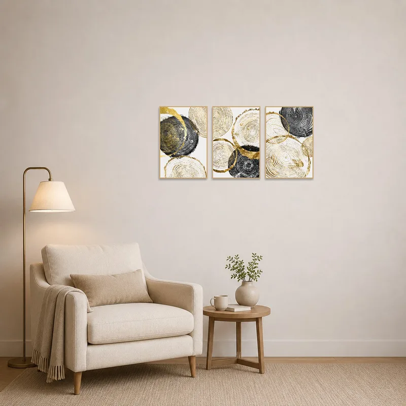 Cozy reading corner enhanced by abstract gold and black tree rings art set.
