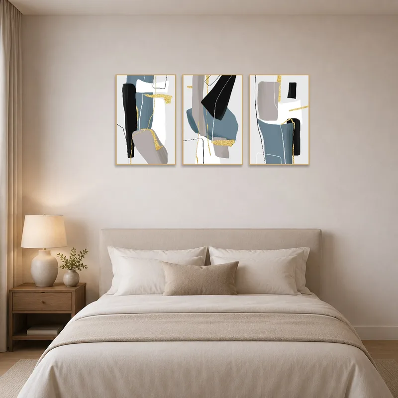 Gold and blue abstract triptych creates a serene atmosphere in a bedroom.