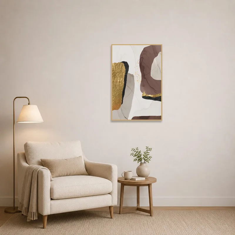 A cozy reading corner adorned with a captivating abstract work in gold and earthy hues.
