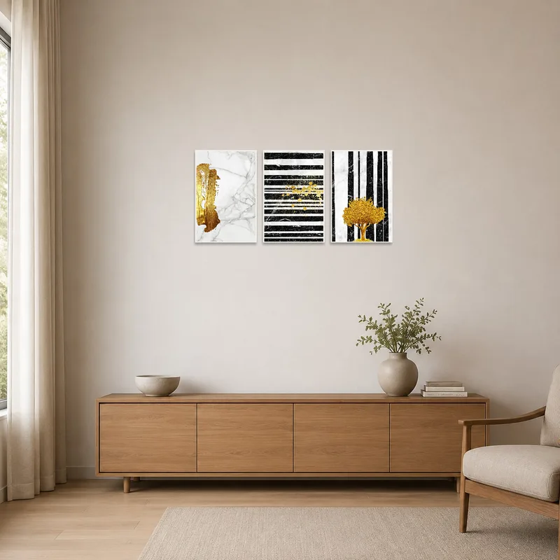 Gold marble triptych art set on a minimalist wall beside sleek furniture.