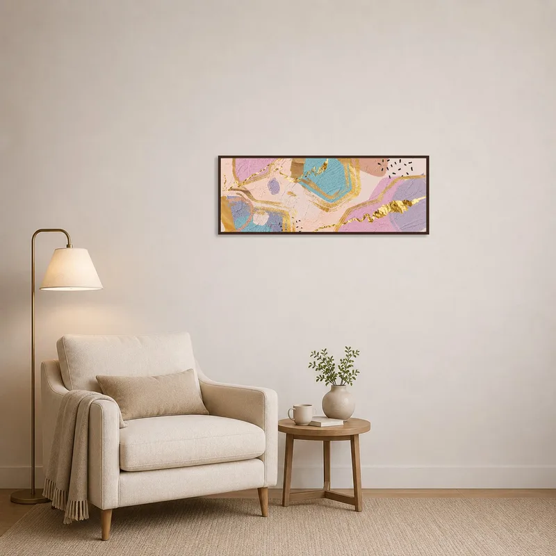 Pastel geometric art on a wall in a cozy reading corner with an armchair and a small table.