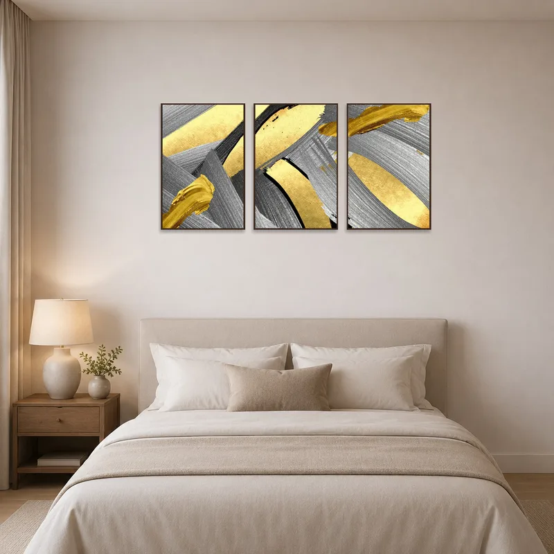 Abstract triptych in gold and silver tones complements calm, soothing bedroom decor.