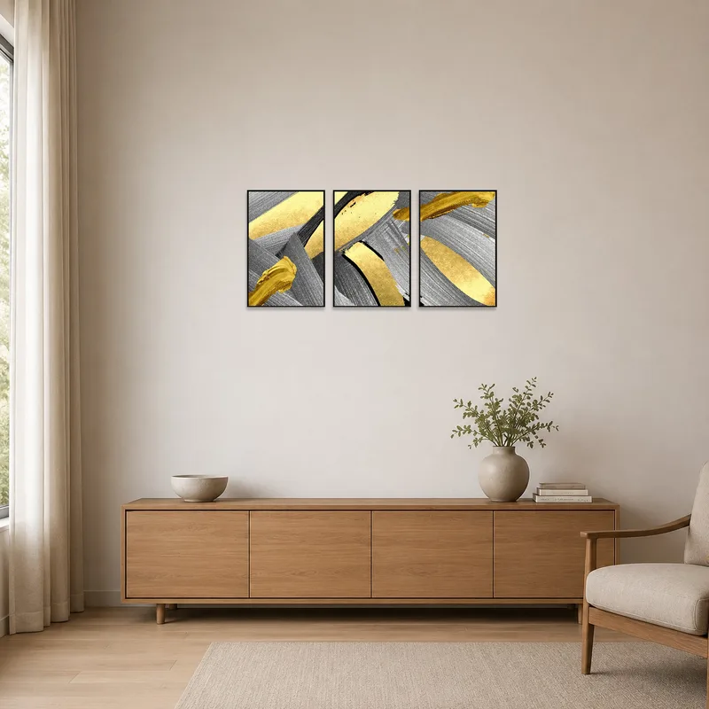 Sophisticated abstract triptych with gold and silver hues adorns a clean, minimalist space.