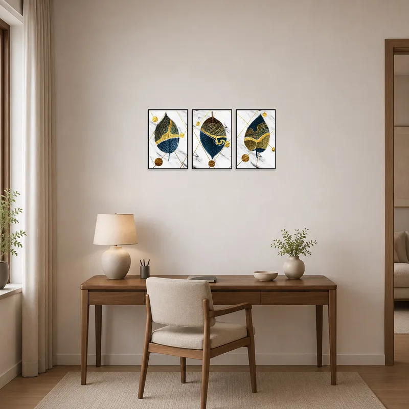Abstract triptych with leaf and gold geometric designs in a home office.