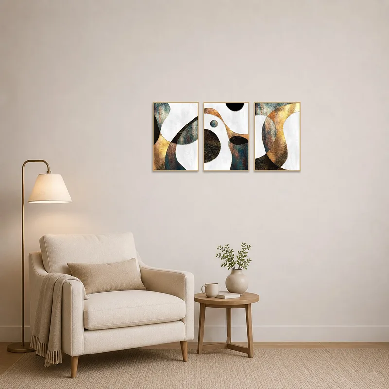 Triptych set with metallic geometric design in a cozy reading corner with a comfortable chair.