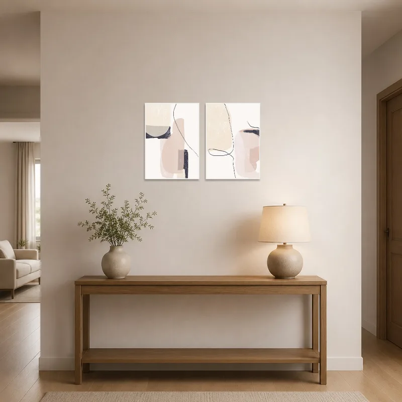 Abstract art set in neutral tones welcomes guests in an elegant entrance hall.