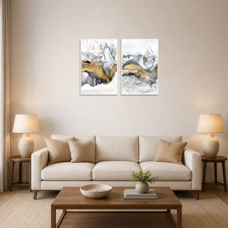 Abstract black, white, and gold art set above a modern grey sofa in a stylish living room.