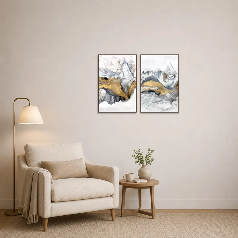Cozy reading corner enhanced by a monochrome and gold abstract art set on the wall.
