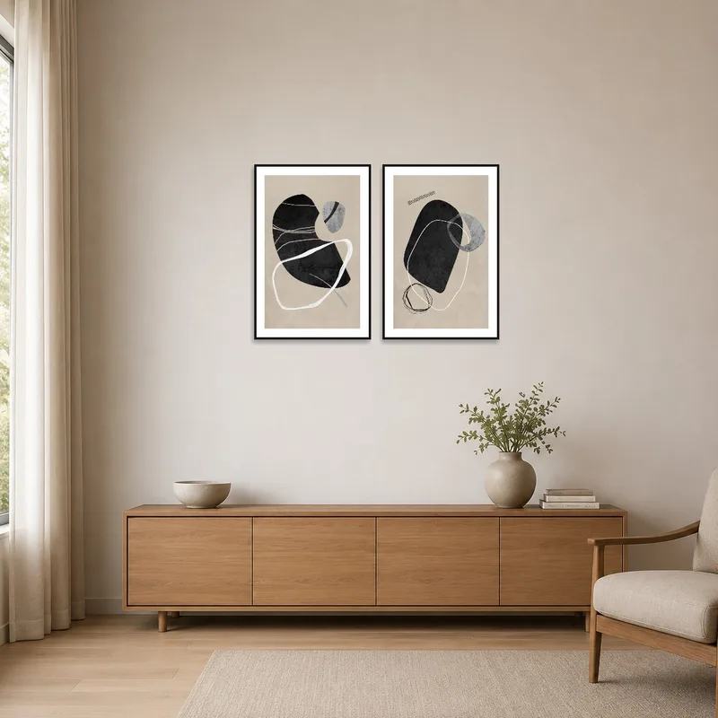 Monochrome forms adorn a minimalist wall, complementing sleek furniture.
