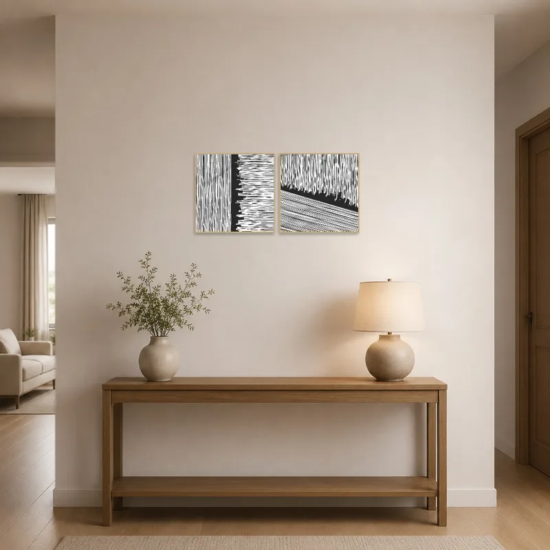 Abstract monochrome line art set adorns the entrance hall wall near a contemporary console table.