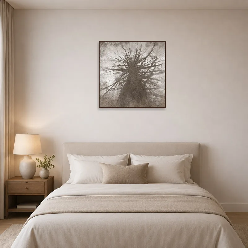 Tree silhouette art complements a serene bedroom with soft lighting.