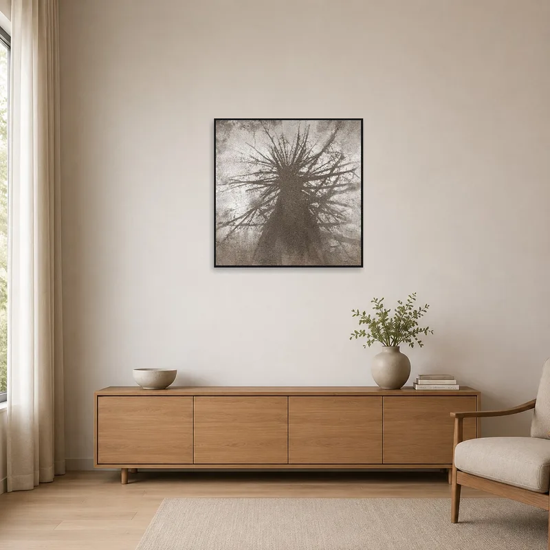 Monochrome tree silhouette art enhancing a minimalist room with neutral tones.