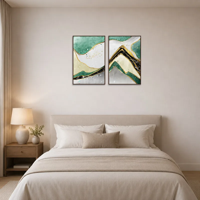 Soothing abstract mountain landscapes with lustrous gold accents hanging in a tranquil bedroom.
