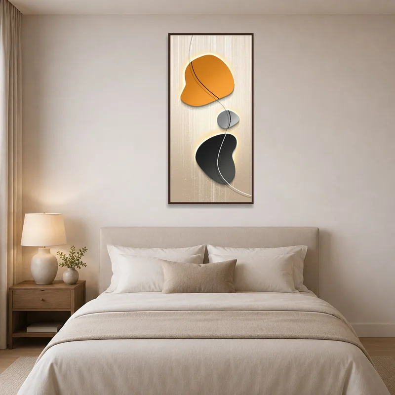 Orange and black shapes bringing warmth to a bedroom wall above a bed.