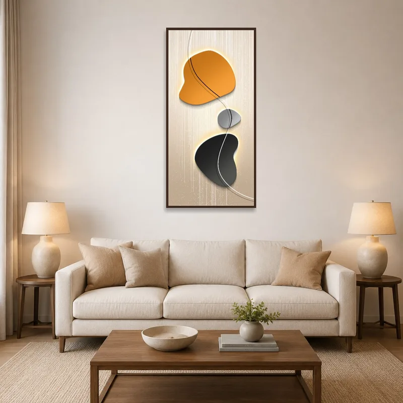 Orange and black abstract art on a stylish living room wall with a gray sofa.
